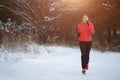 Picture of brunette in sports uniform on morning run in winter Royalty Free Stock Photo