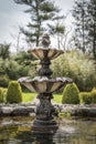 Bubbling stone water fountain in the middle of a garden Royalty Free Stock Photo