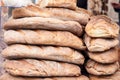 Piles of loafs of bread, artisanal white bread, on display on a street bakery, ready to be eaten