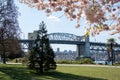 A picture of Burrard bridge, with signs of spring in the foreground.