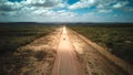 A car on a dirt road leading to the Addo Elephant National Park, near Port Elizabeth from a drone