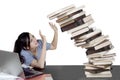 Caucasian student with falling books on studio