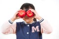 The picture of a child holding a red and green apple