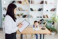 Picture of child psychologist working with young boy in office