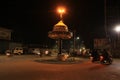 Chowk in Town at Night With Passing Traffic