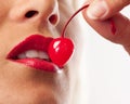 Picture of cocktail cherry, lips and white teeth