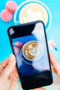 Picture of a coffee on a smartphone on a blue table. Royalty Free Stock Photo