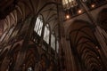 Selective blur on the stained glass windows and the gothic vaults in the interior of the Cologne Cathedral during a dark day.