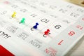 Picture of colorful pushpin on the white calendar