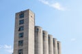 High Concrete Wheat Silo, old and abandoned, in an agricultural industry of Serbia, in Europe, with a blue sky in background Royalty Free Stock Photo