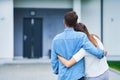 Couple in front of one-family house in modern residential area Royalty Free Stock Photo