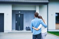 Couple in front of one-family house in modern residential area Royalty Free Stock Photo