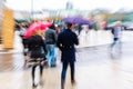 People walking in the rainy city with zoom effect Royalty Free Stock Photo