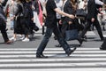 crowds of people crossing a city street on the zebra crossing in Tokyo, Japan Royalty Free Stock Photo