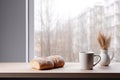 Picture of cup of coffee and loaf of bread on table. This image can be used to depict cozy breakfast or coffee break sce Royalty Free Stock Photo