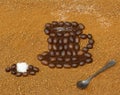 Picture a cup of coffee with sugar cube and spoon on a background from granulated coffee Royalty Free Stock Photo