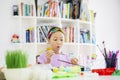 Shocked little girl painting eggs for Easter