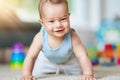 Cute smiling baby boy crawling on floor in living room Royalty Free Stock Photo