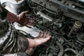 Picture of dirty hands of a guy above the engine Royalty Free Stock Photo