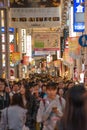 A picture of Dotonbori street filled with people and signs.