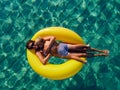Picture with drone of people, floating on inflatable colorful rings in the sea Royalty Free Stock Photo