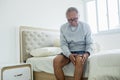 Elderly man suffering from knee pain at home Royalty Free Stock Photo