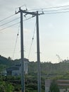 picture of electric poles/cables and a special building for swallows in the middle of the garden