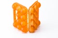 Picture of Empty Obsolete Orange Egg Hiolder. Placed Against White Background