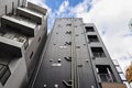 Facade of a Japanese residential building with external sewage pipes