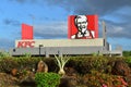 Picture of the facade of a KFC restaurant with the famous colonel Sanders face best known for founding fast food chicken restauran