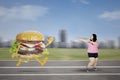 Fat woman escaping from a burger