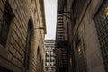 Fire escape stairs and ladder, in metal, on a typical North American old stone building from the Old Montreal, Quebec, Canada Royalty Free Stock Photo