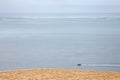 Boat sailing on the Atlantic ocean during a rain story under a cloudy sky passing next to the Pyla Dune. Royalty Free Stock Photo