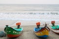 This is a picture of fishing boats parked near the seashore