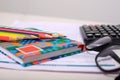 Picture of form, notebook, colorful pencil, calculator and glasses