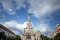 Panorama of the statue of trinity, or szentharomsag szobor in front Downtown Candlemas Church of the Blessed Virgin Mary. It is a Royalty Free Stock Photo