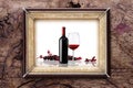 Picture frame bottle and glass of wine on wooden backgrounds Royalty Free Stock Photo