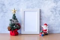 Picture frame and Christmas decoration - Santa Clause, tree and gift on wooden table. Christmas and Happy new year concept Royalty Free Stock Photo