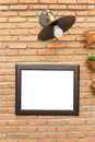 Picture frame and classic lamp on brick wall Royalty Free Stock Photo