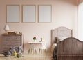 Picture frame on a cream colored wall in a children`s room with a bed by the window, decorated with dolls and toys on the wooden