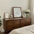 Picture frame and flowers on a dresser in a contemporary bedroom. (Picture in frame is mine.)