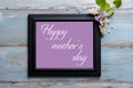 Picture frame with lilac flowers and Happy Mother`s day message on blue background