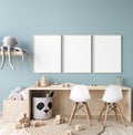 Picture frame mock up in nursery interior, wooden desk on blue wall background Royalty Free Stock Photo