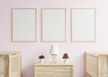 Picture frame on the pink wall in the child`s bedroom. There was a newborn bed on the side and a lamp and flower pot placed on th Royalty Free Stock Photo