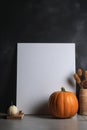 A picture frame with a pumpkin and other decorations. Generative AI image. Blank poster mockup.