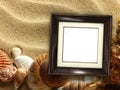 Picture frame on shells and sand background Royalty Free Stock Photo