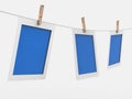 Picture frame and white backgroundPhoto frames hang with laundry clamps on a white background 3D rendering