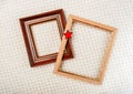 Picture frames with gilding and red star close-up on white woolen plaid background