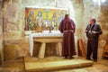 Friar and Tourist guide at the Chapel of the Innocents, Church of the Nativity, or Basilica of the Nativity, Bethlehem