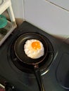 this picture is about fried egg in sunny upside down on nonstick pan Royalty Free Stock Photo